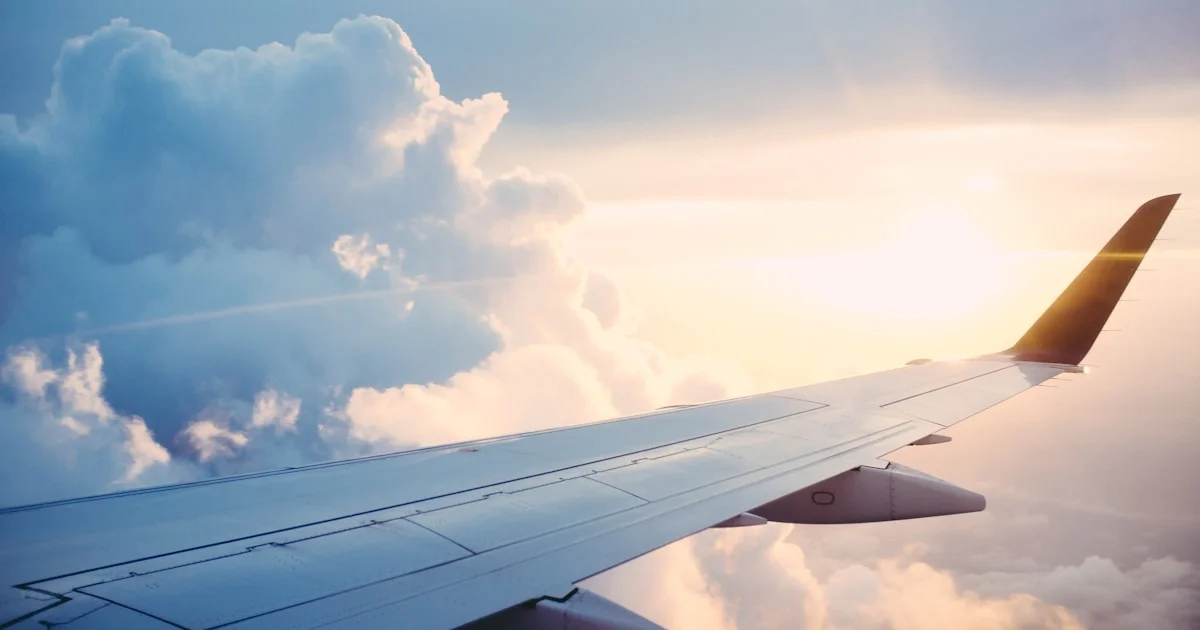 Commercial airplane on a runway at sunset