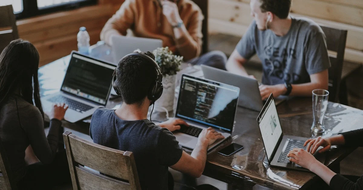 Team of colleagues working together at computers