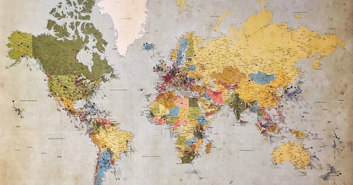 World map with destination markers on a wall